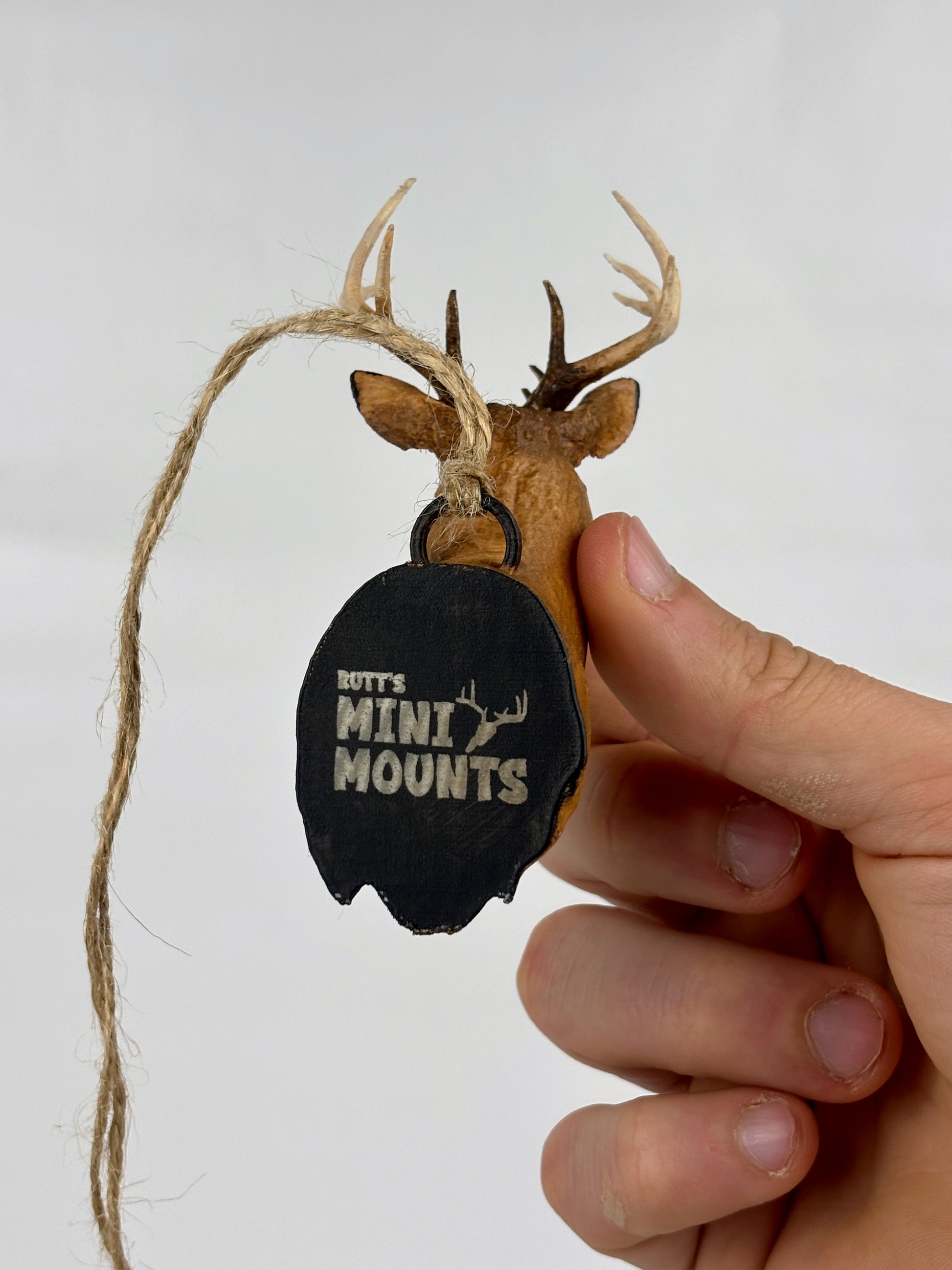 Elevate your hunting trophies with Rutt's Mini Mounts! Transform euro mounts, skulls, shoulder mounts, or sheds into handpainted mini replicas. Ideal for outdoor enthusiasts, hunters, and perfect as a gift for dads. Display proudly on your desk or rearview mirror. Suitable for various animal trophies. Great for desk or car decoration